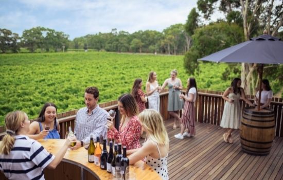 People drinking wine and enjoying themselves at the patio